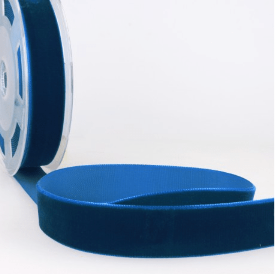 A roll of dark blue velvet ribbon with a textured edge.