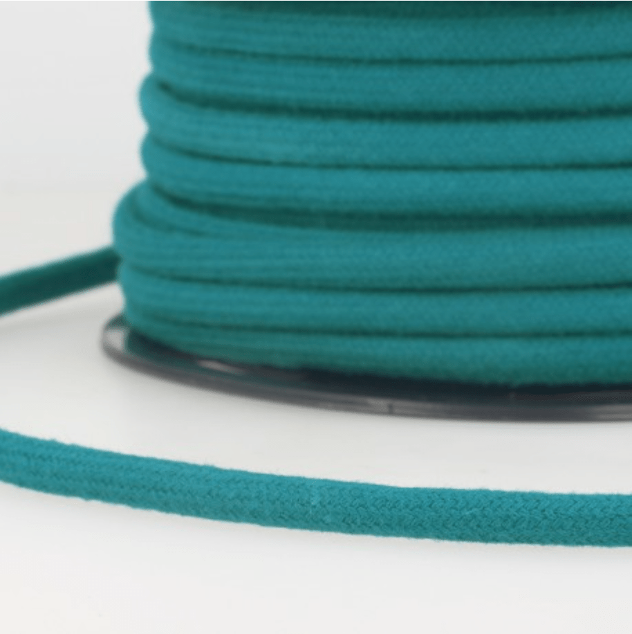 Rolled teal 4mm cotton cord with a loose end.