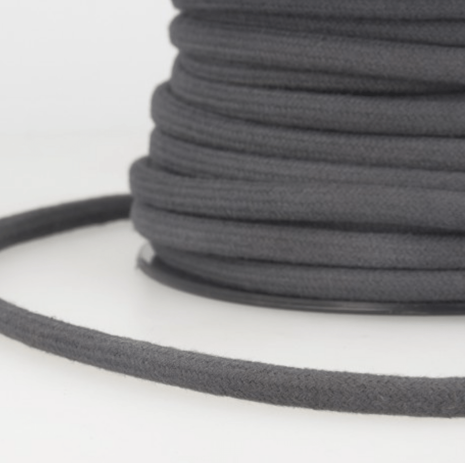 A spool of dark gray 4mm cotton cord for crafts.