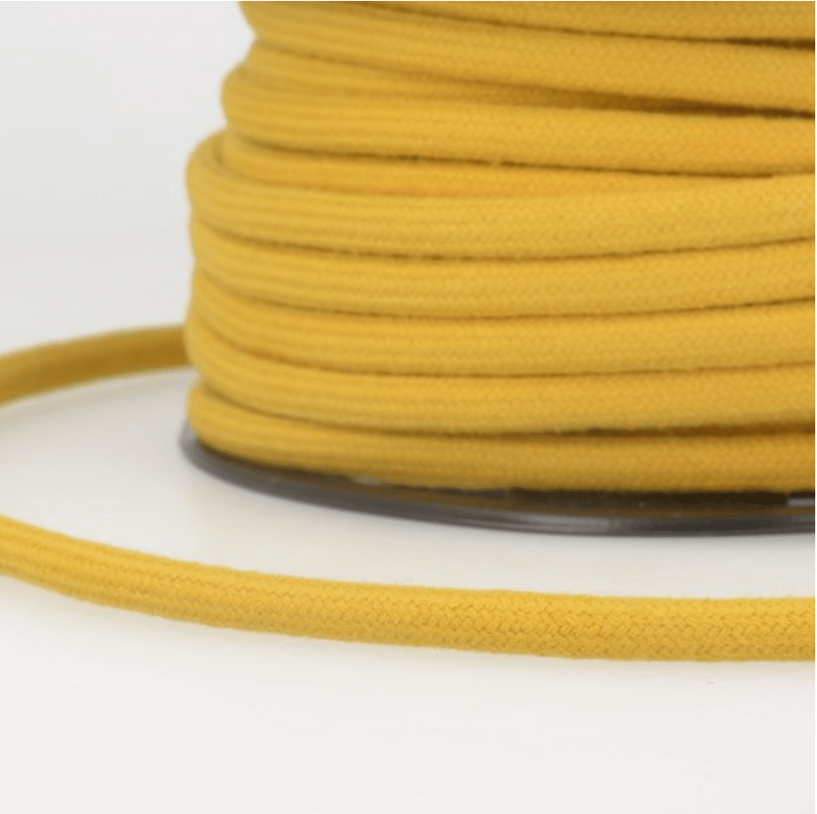 A spool of yellow 4mm cotton cord for crafts.