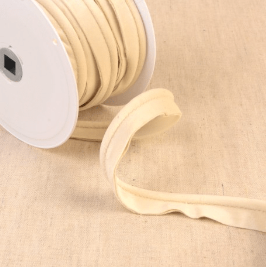 Stephanoise velvet piping cord in a light cream color on a spool.
