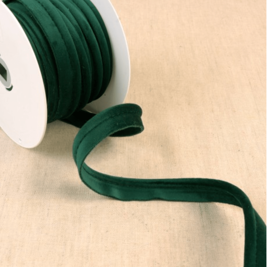 Dark green velvet piping cord on a white spool.