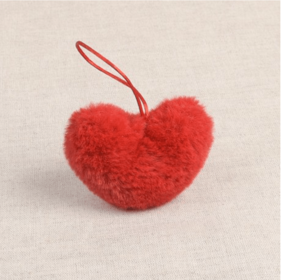A red faux fur heart-shaped pompon with a hanging loop.