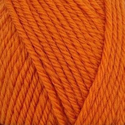 Close-up of Stylecraft Naturals Pure Wool DK yarn in a vibrant orange spice shade.