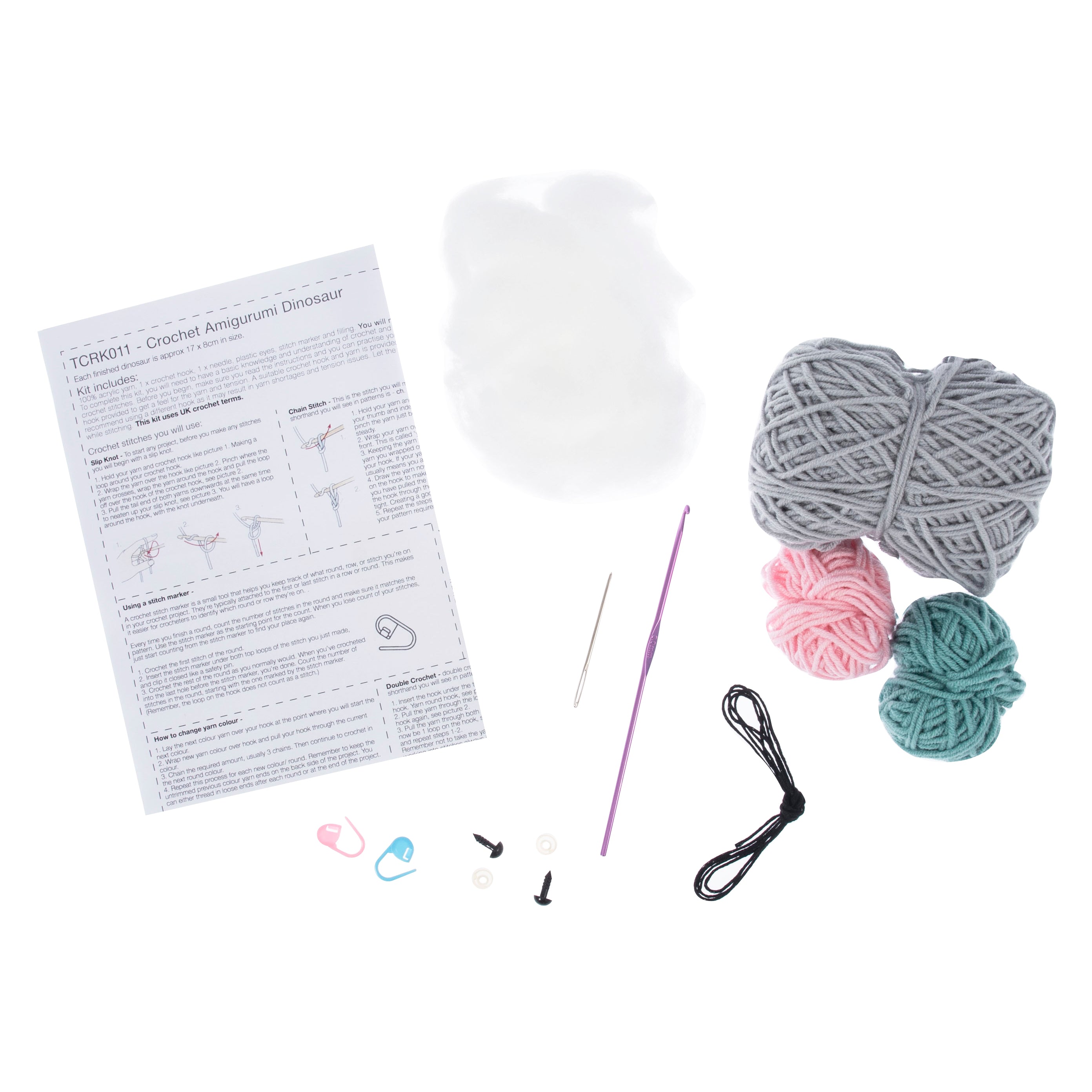 Crochet amigurumi dinosaur kit featuring yarn, stuffing, a crochet hook, and instruction sheet.