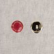 Two buttons, one red and one silver, on a white background.
