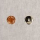 Two 21mm round buttons, one copper enamel and one silver metal.
