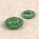 Two green, textured eco-friendly buttons made from rice husk and polyester.