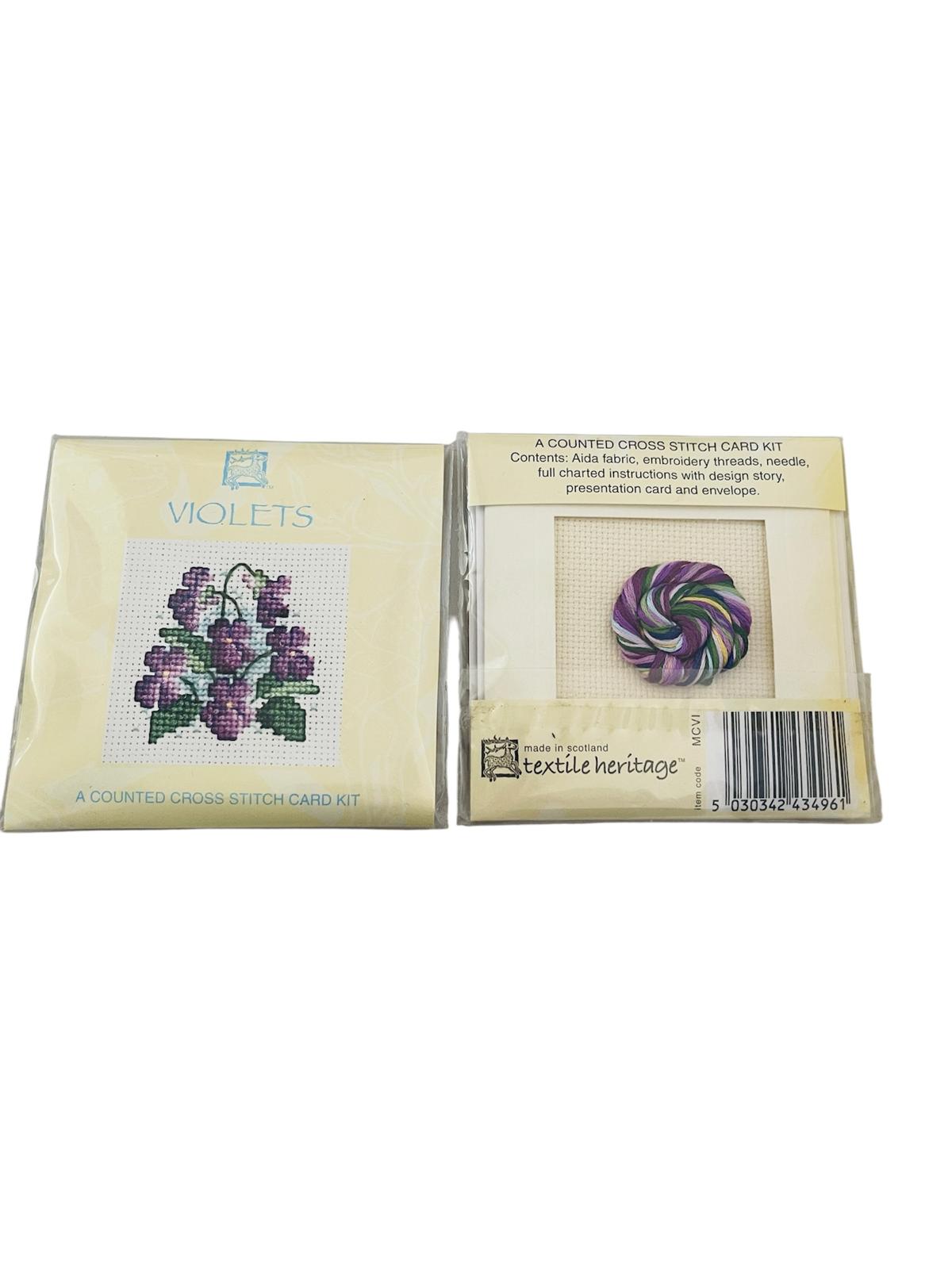 Textile Heritage Violets counted cross stitch card kit with fabric, threads, and instructions.