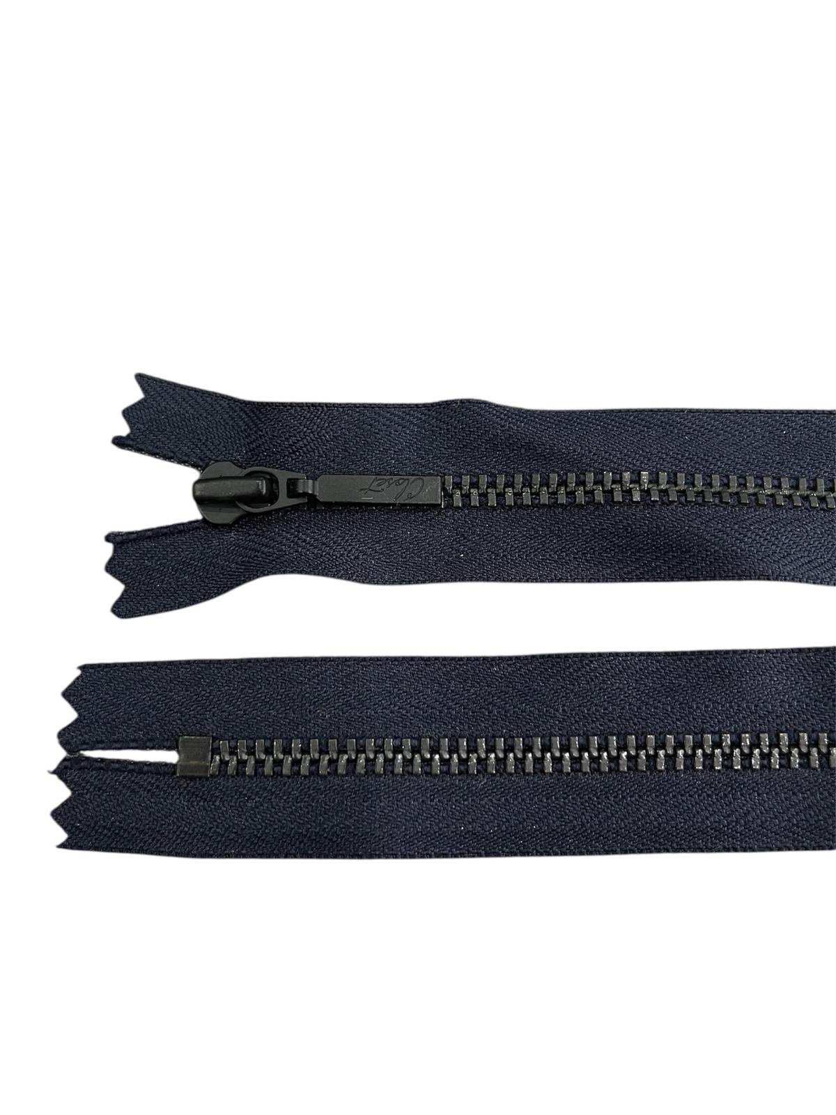 Black metal YKK zipper with closed end and metal teeth.