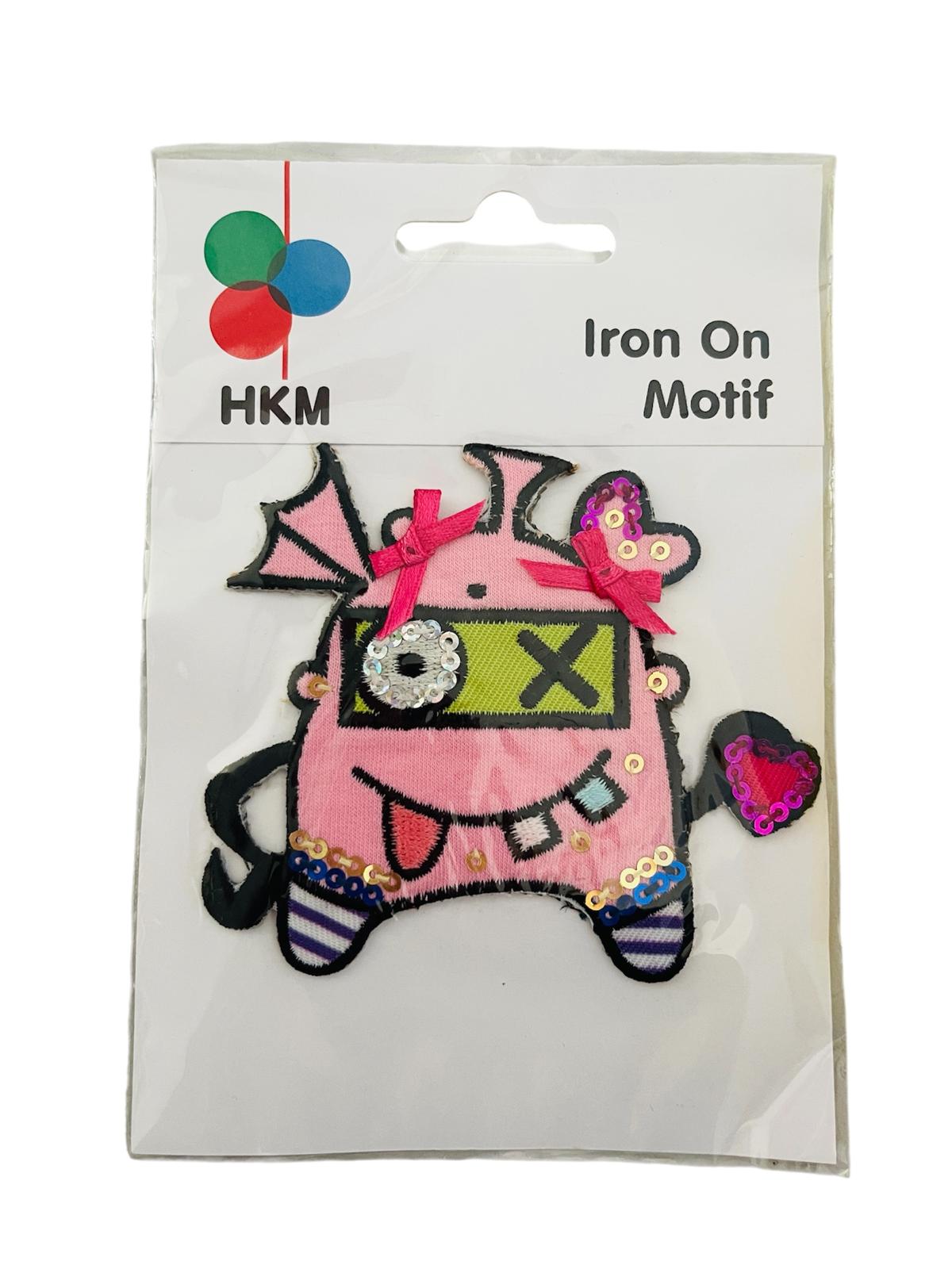Crazy Alien Doll iron-on patch with pink fabric, sequins, and bows in its original packaging.