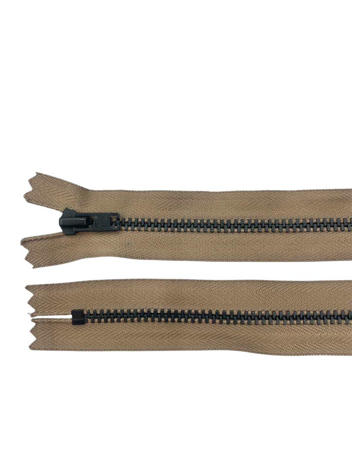Two tan zippers with black metal teeth, one with a black slider.