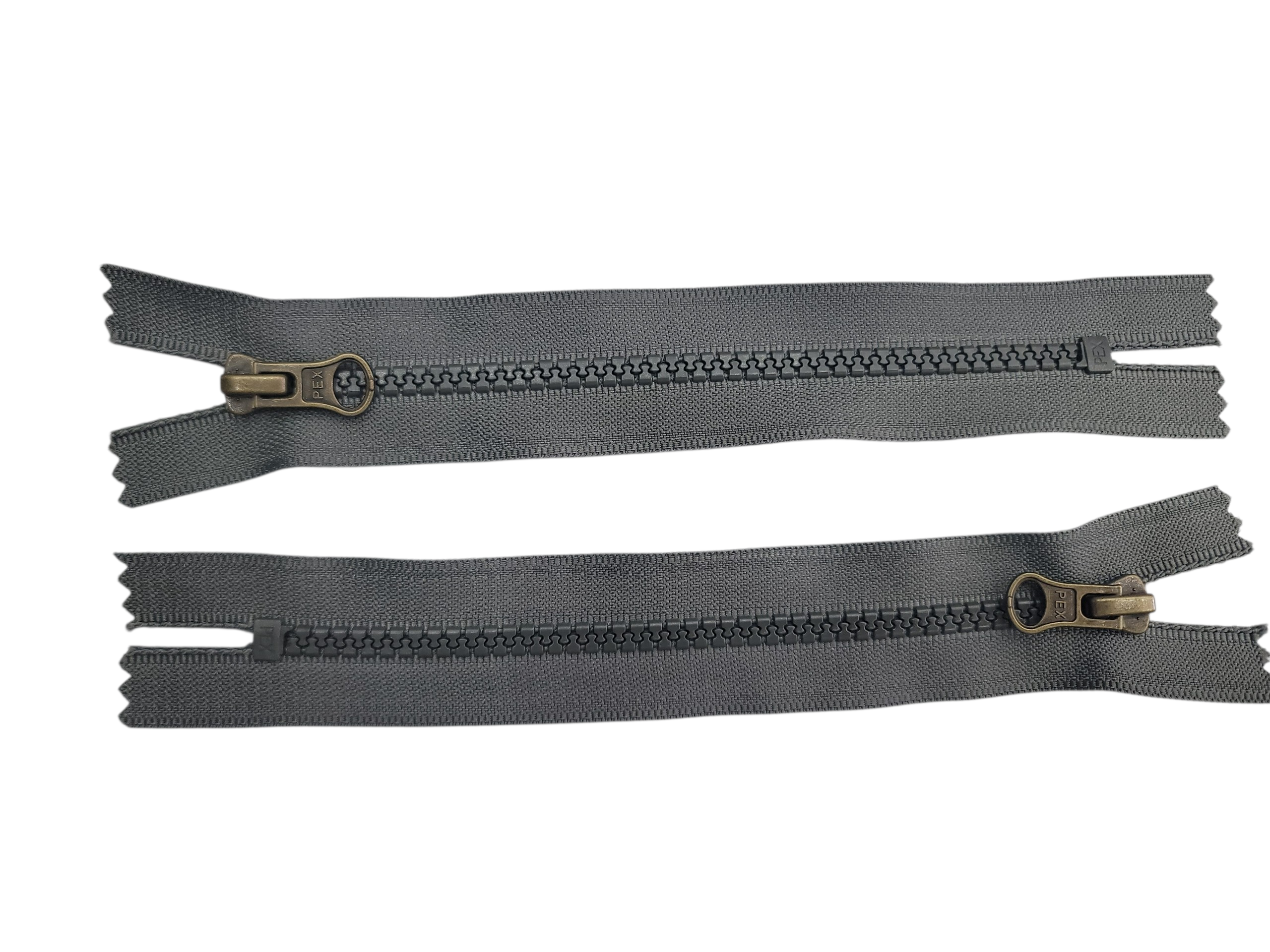 Two 16cm closed-end chunky zippers in petrol grey with antique brass sliders on a white background.