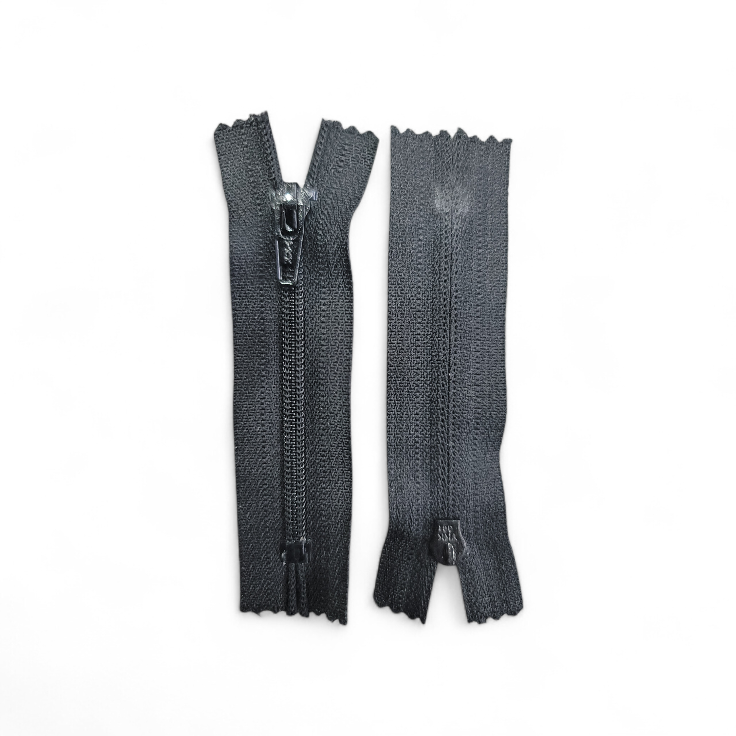Grey YKK 8cm closed end plastic zipper with metal pull tab.