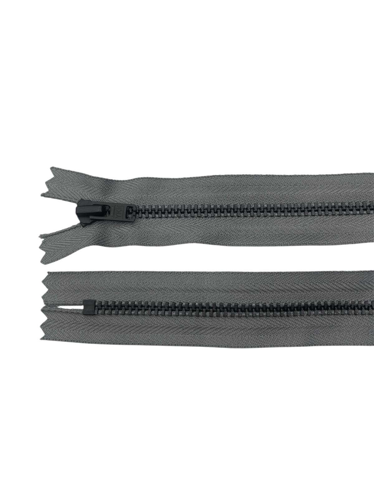 Two grey YKK zippers with black metal teeth on a white background.