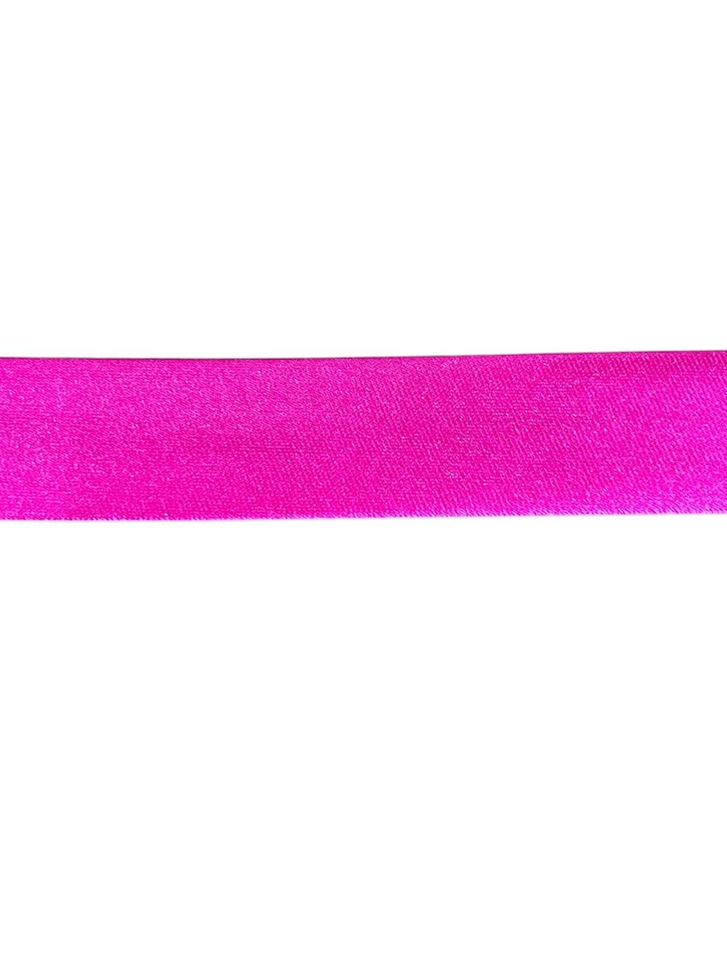 Close-up of bright pink satin bias binding tape for sewing and crafting.