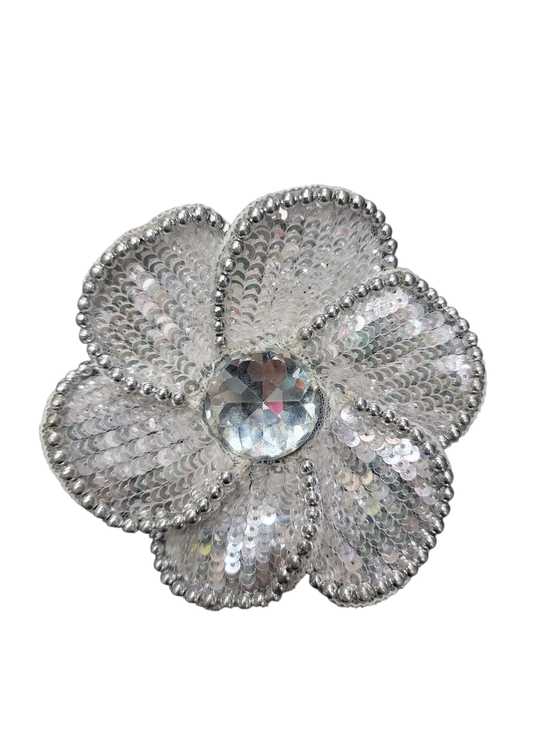 Hand-embroidered silver and ivory sequin flower accessory with a central clear gem.