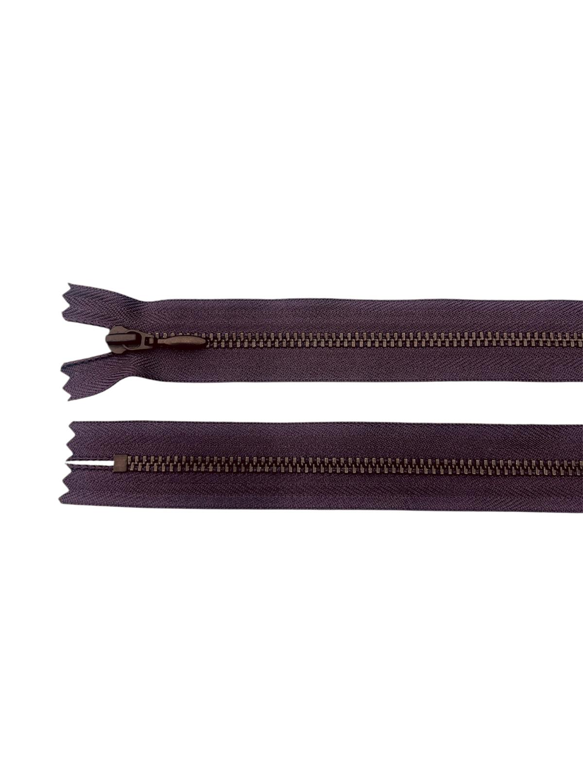 Two dark purple zippers with black metal teeth on a white background.