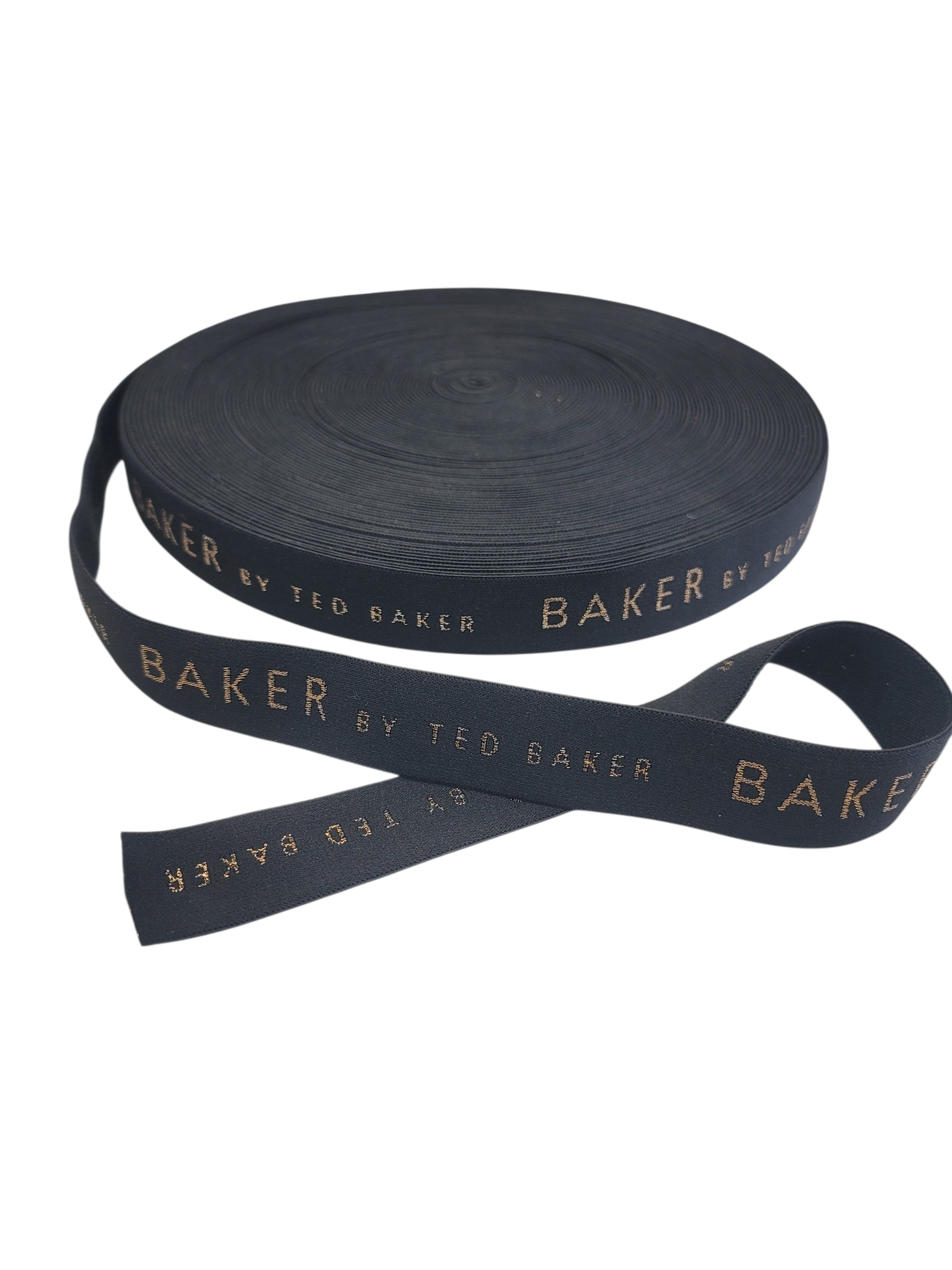 A roll of 35mm black elastic tape featuring woven gold Ted Baker branding.