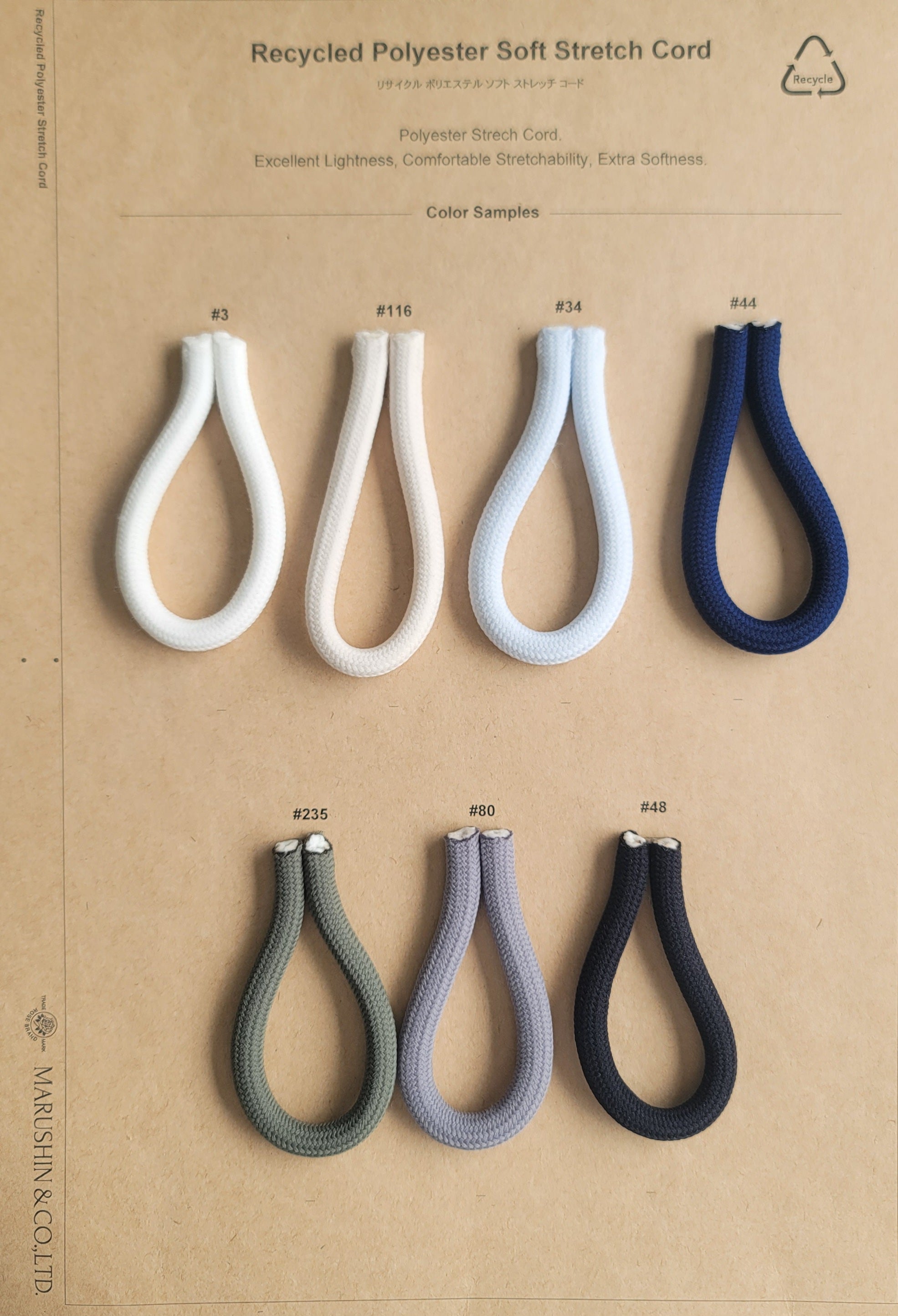 Seven loops of 6mm soft stretch recycled polyester cord in various colors on a sample board.