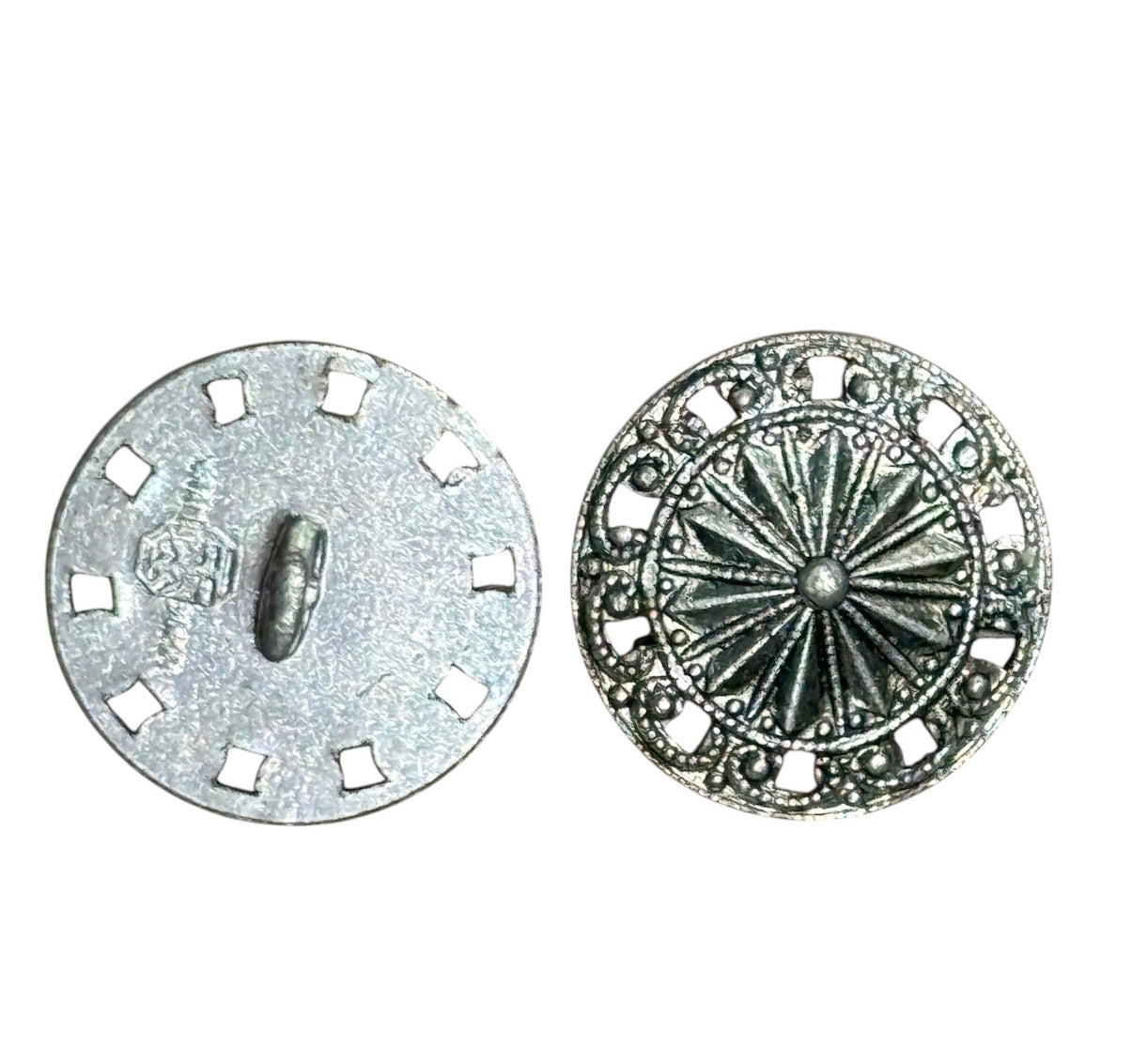 Front and back view of an 18mm silver button with a sunburst design and filigree border.