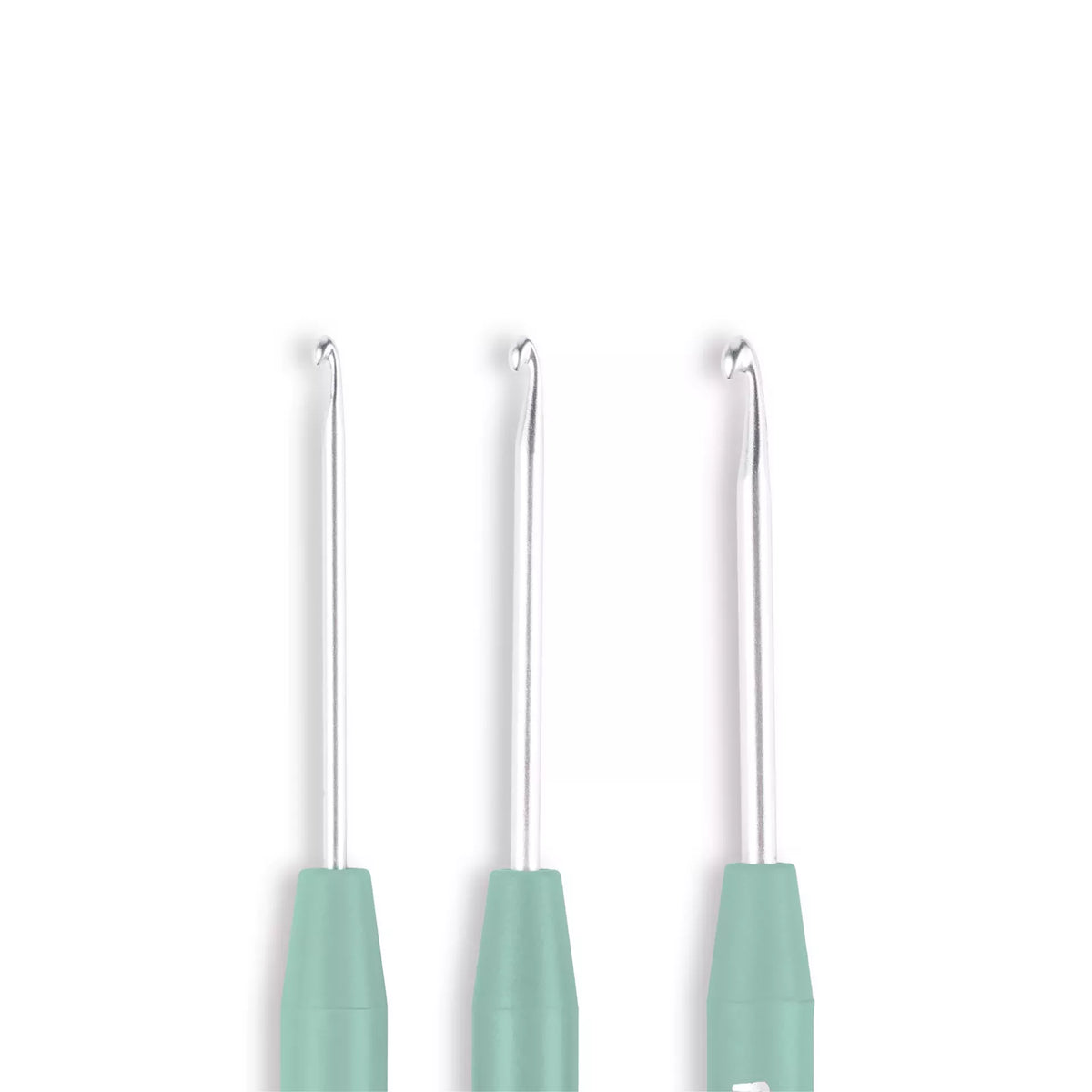 Set of three silver amigurumi crochet hooks with linden green soft-grip handles.