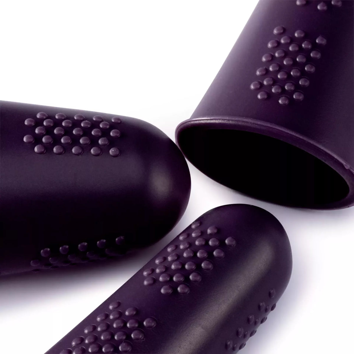 Three plum-colored silicone finger guards with textured burled surfaces for heat protection.