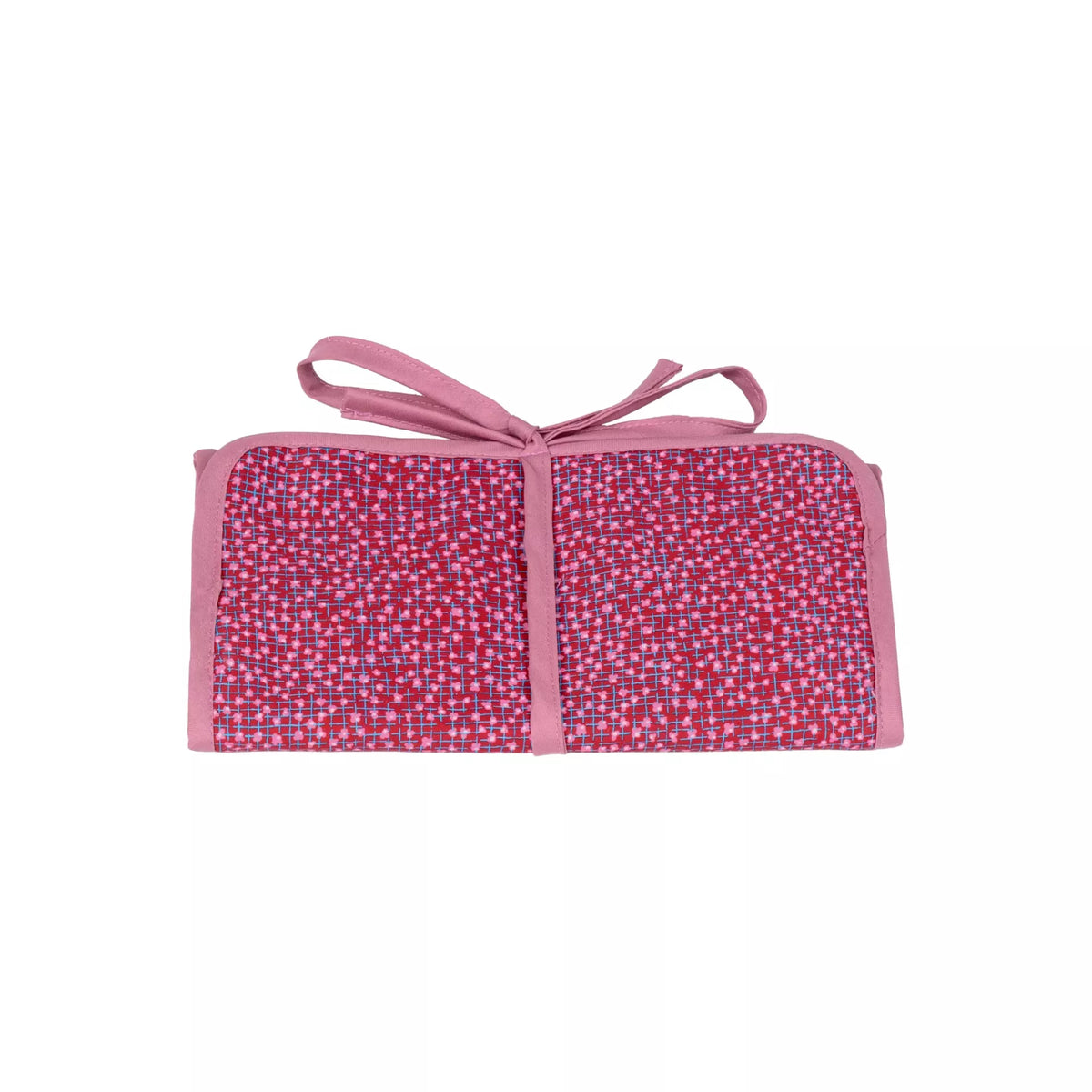 Rolled burgundy and old rose patterned cotton needle case tied with a ribbon.