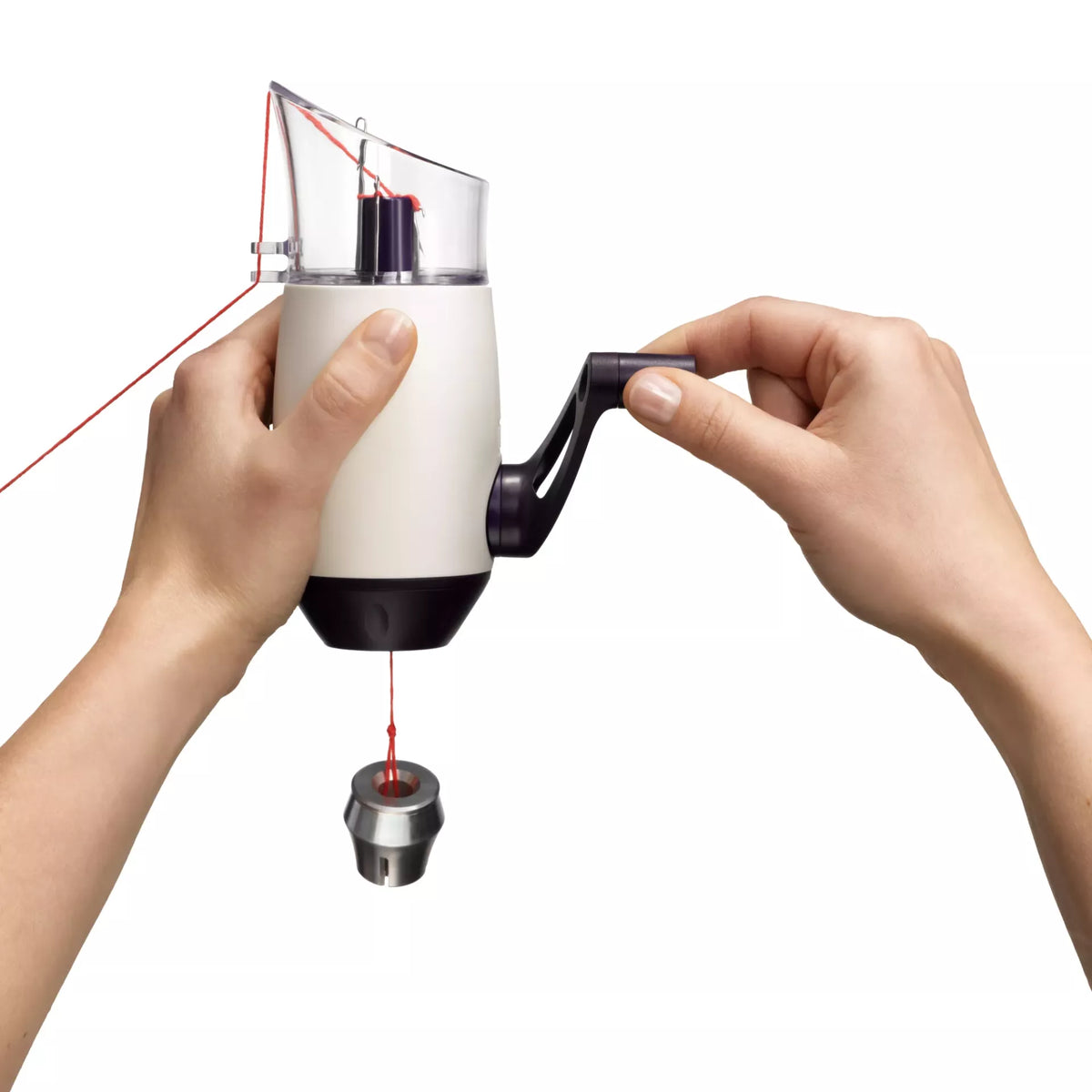 Hands operating the Comfort Twist knitting mill with red yarn and attached weight.
