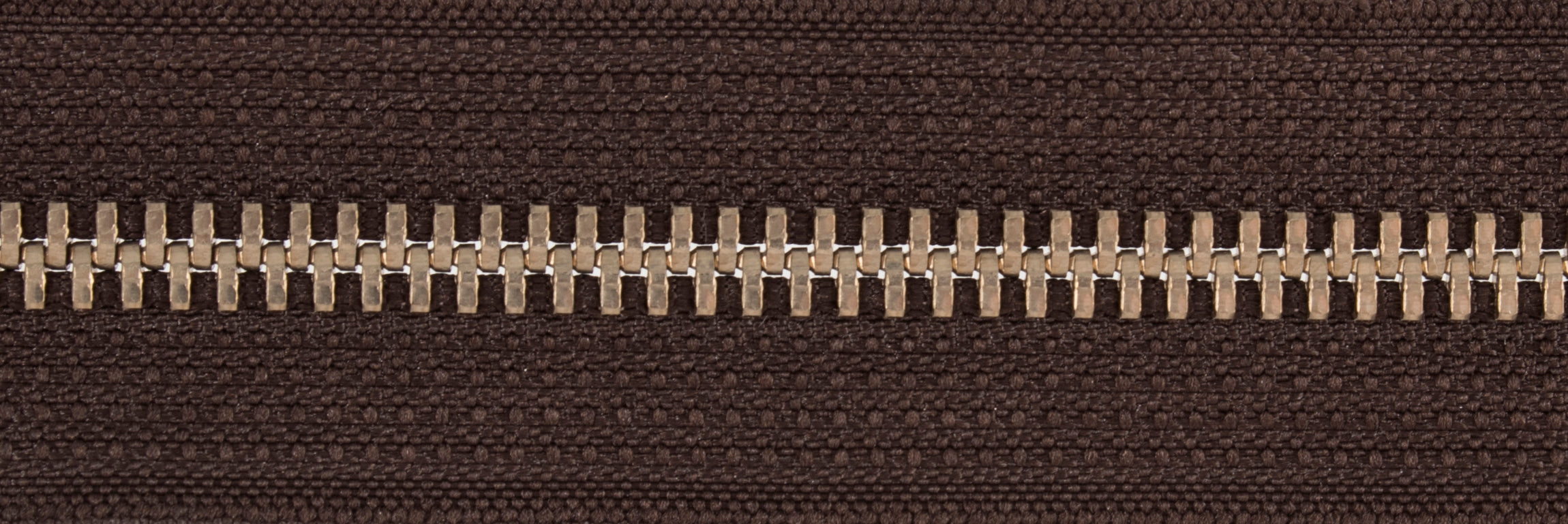 Galedi metal open end zip in silver and light gold with brown fabric.