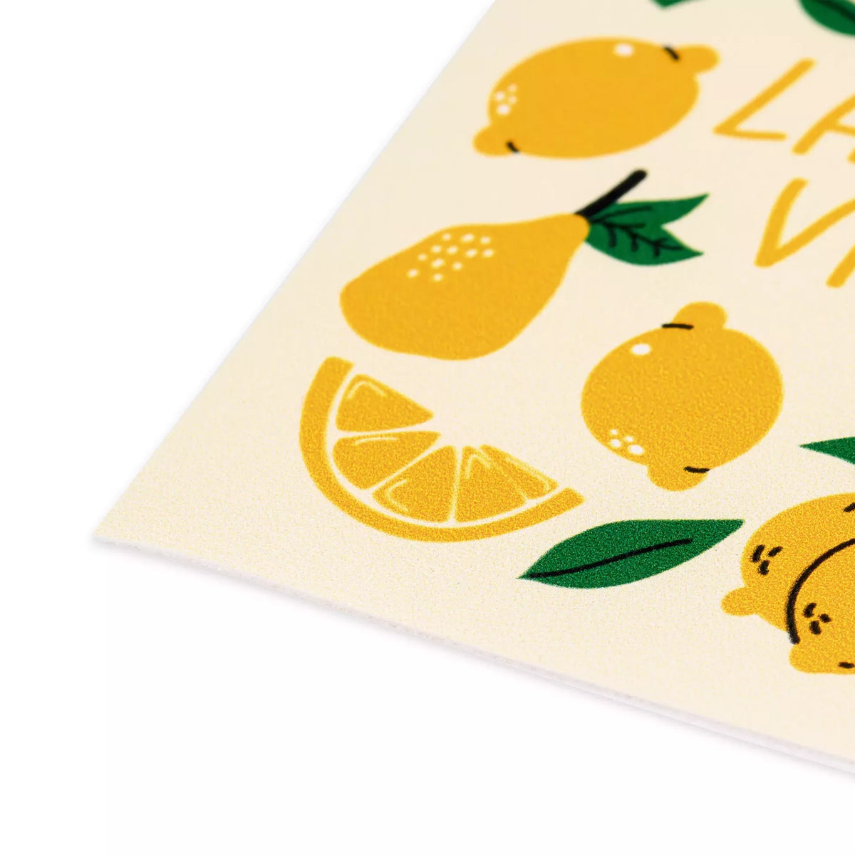 Close-up of a multicoloured lemon-themed appliqué patch on a cream background.