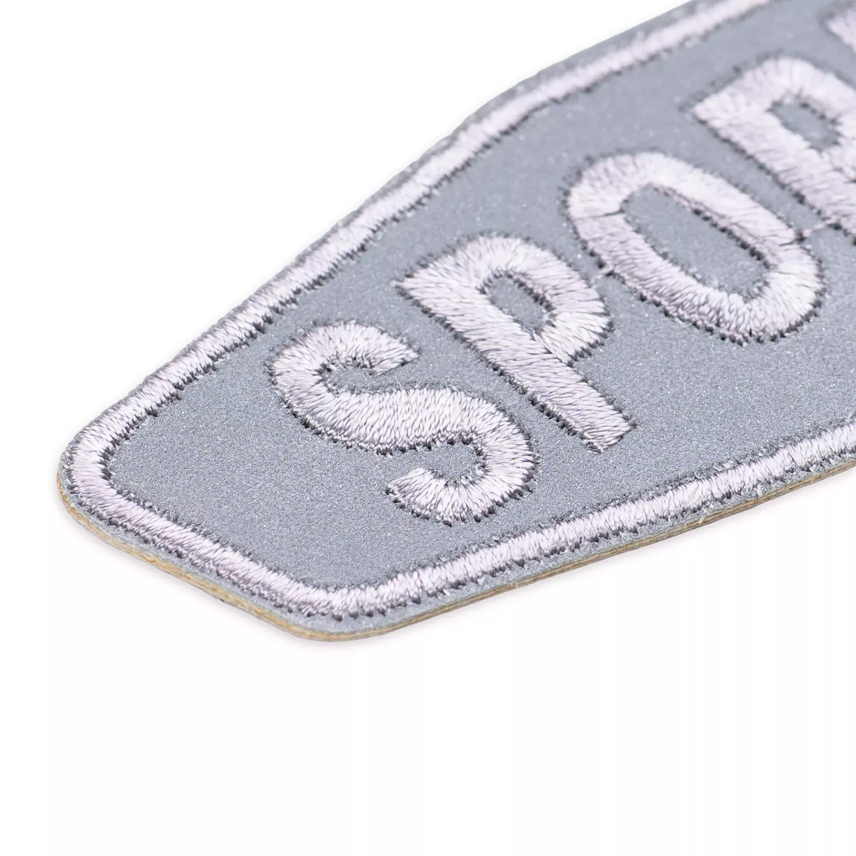Grey reflective sport appliqué patch with white embroidered lettering and border.