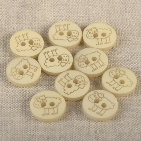 A collection of ten round, cream-colored 15mm polyester buttons featuring an engraved sheep design.