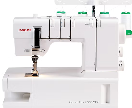 Janome 2000CPX coverstitch machine with free arm and multiple thread spools.