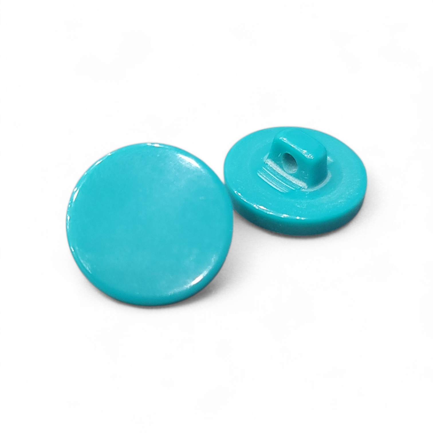 Two turquoise polyester shank buttons, one flat and one with a raised shank.