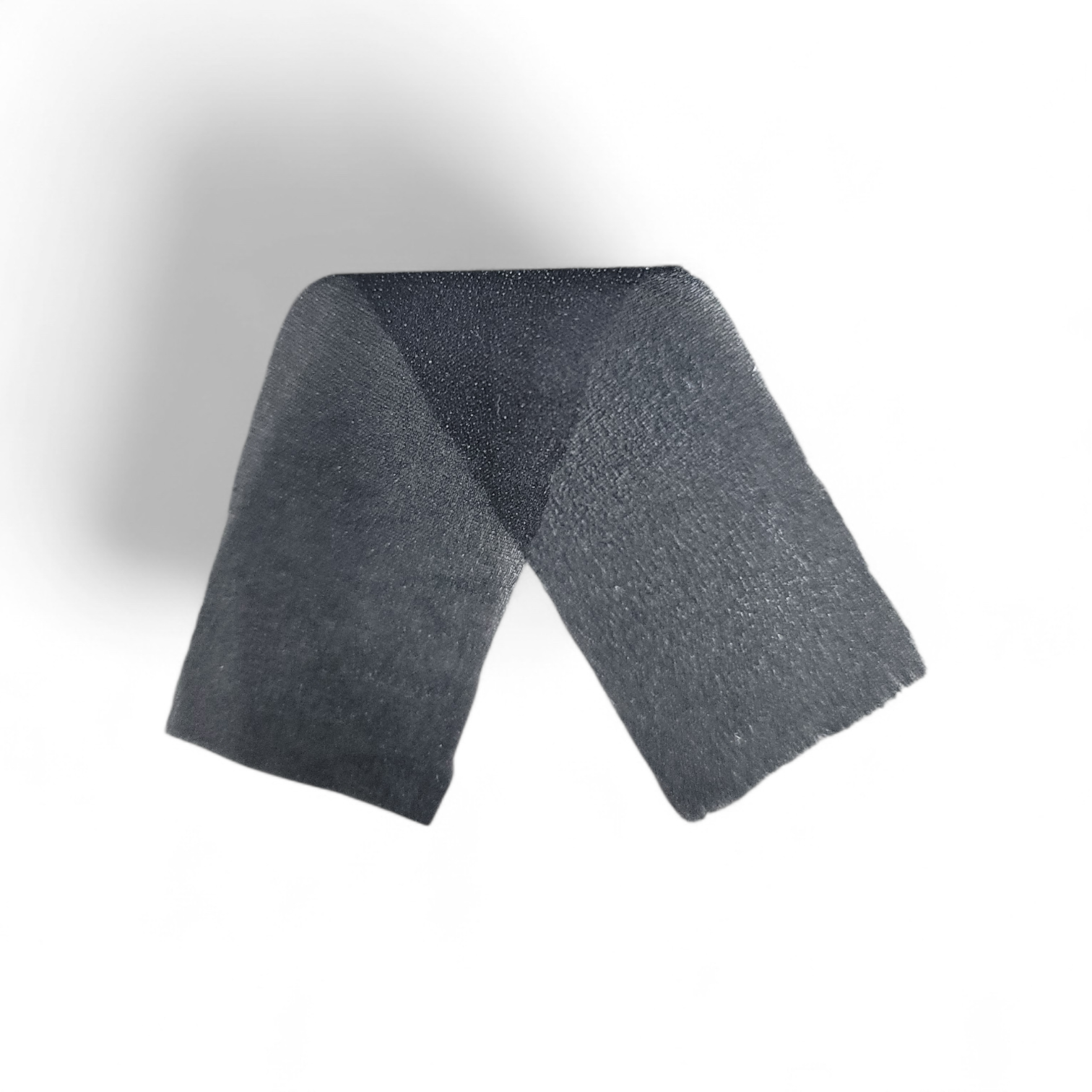 Dark grey bi-elastic fusible interlining tape folded in a V-shape.