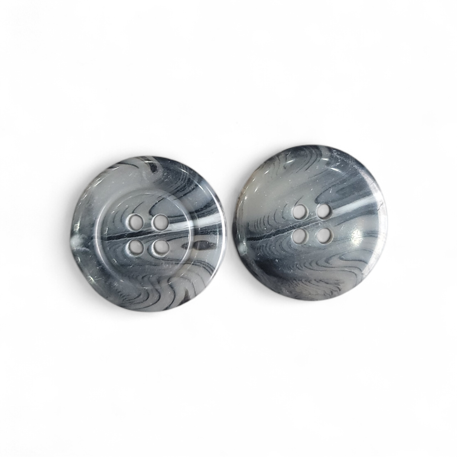 Two grey 23mm 4-hole polyester buttons with a marbled pattern.