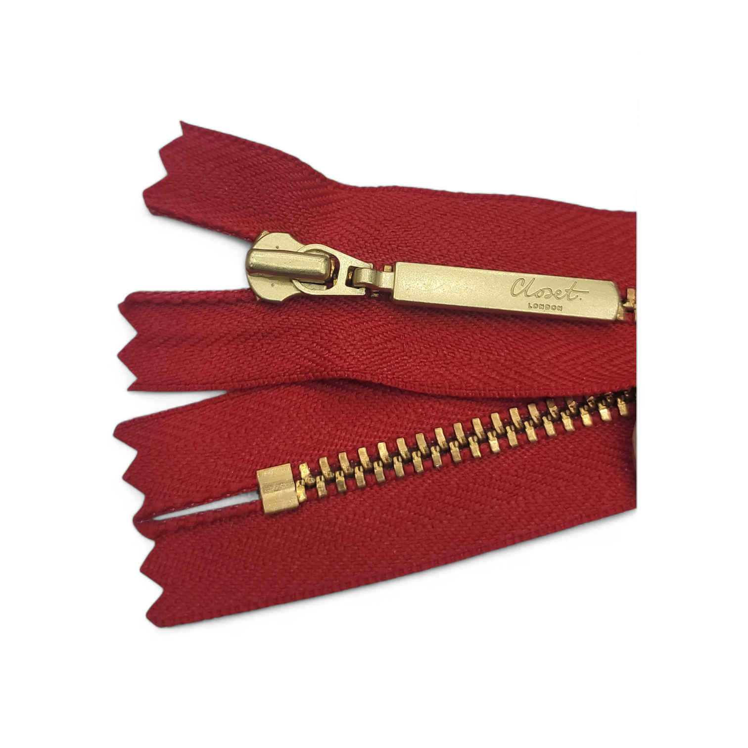 Red zipper with gold metal teeth and pull tab.
