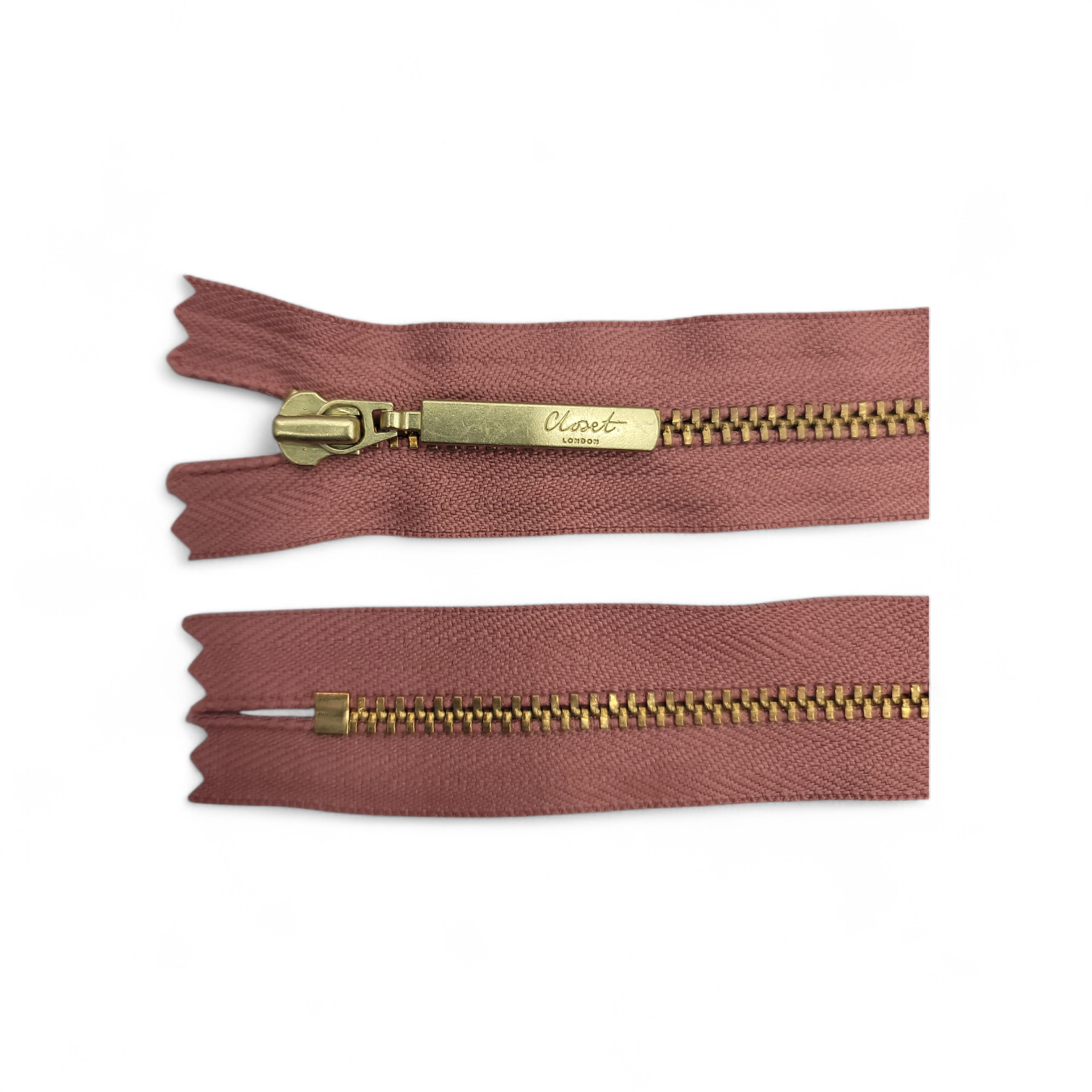 YKK Size 3 closed end gold metal zip with pink tape.
