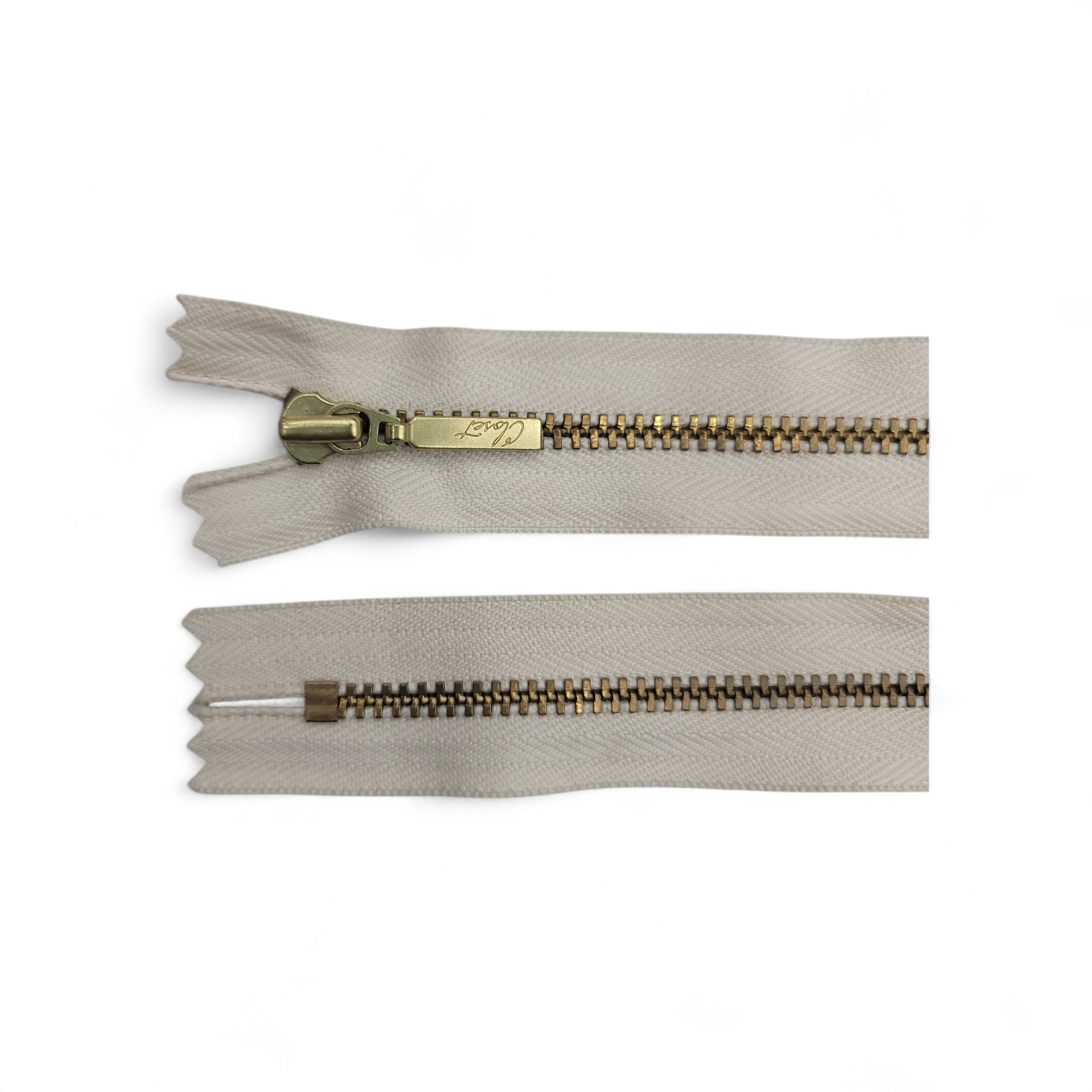 YKK size 3 closed end gold metal zip with beige fabric.