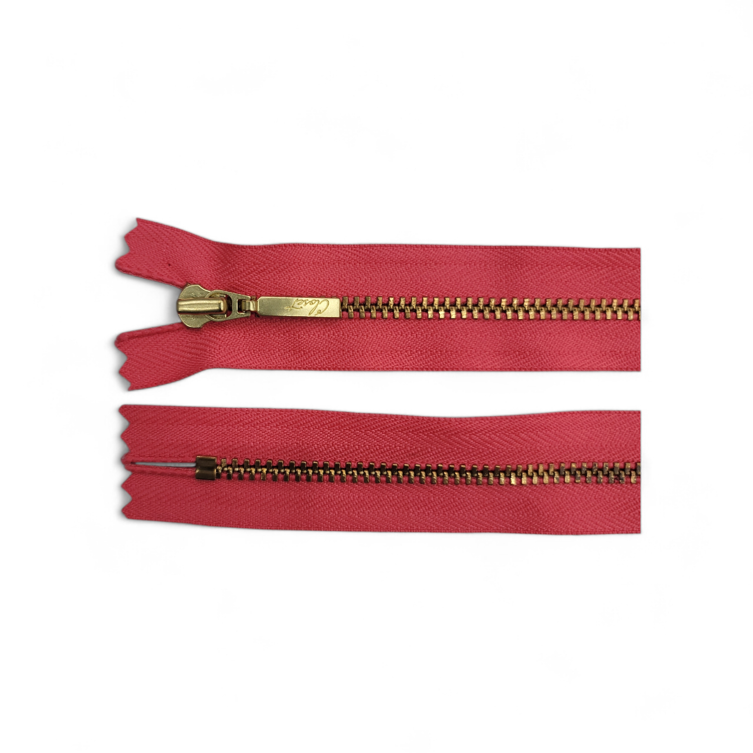 YKK size 3 closed end gold metal zipper on red fabric.