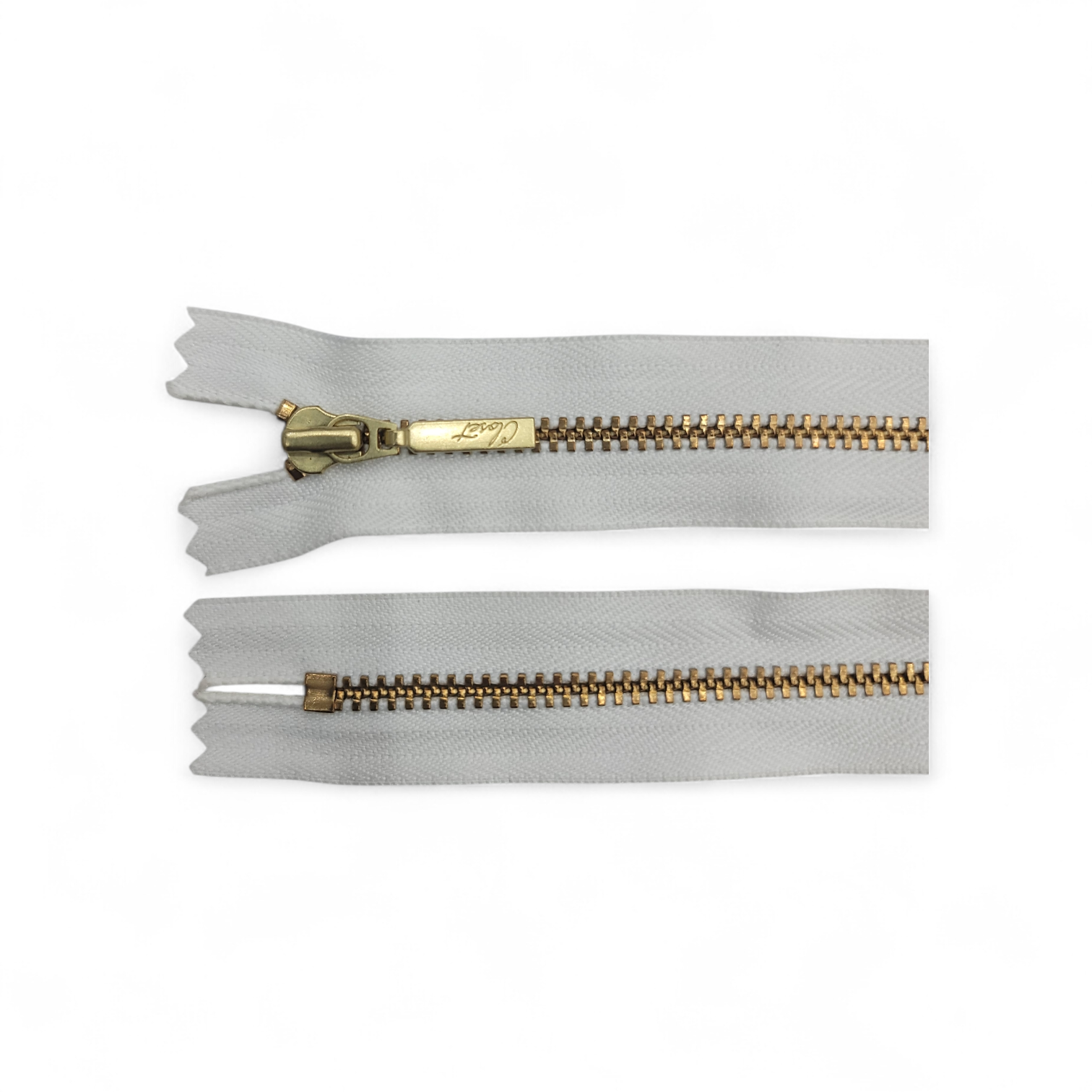 YKK size 3 closed end gold metal zip with light grey tape.