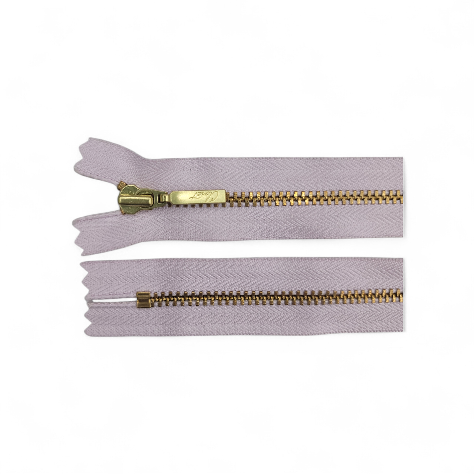 YKK size 3 closed end gold metal zipper with light purple tape.