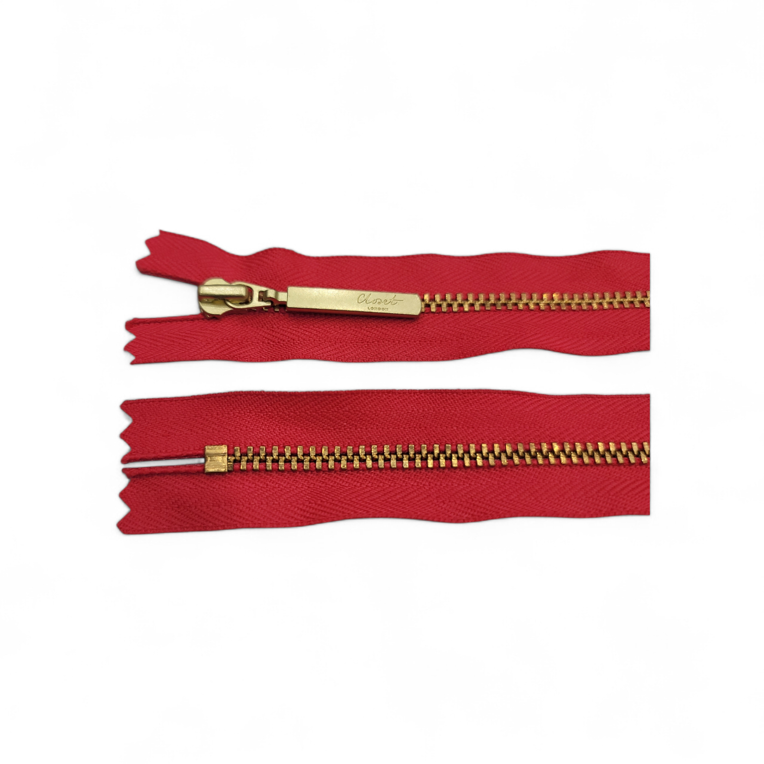 Red YKK closed end gold metal zipper with brass teeth.