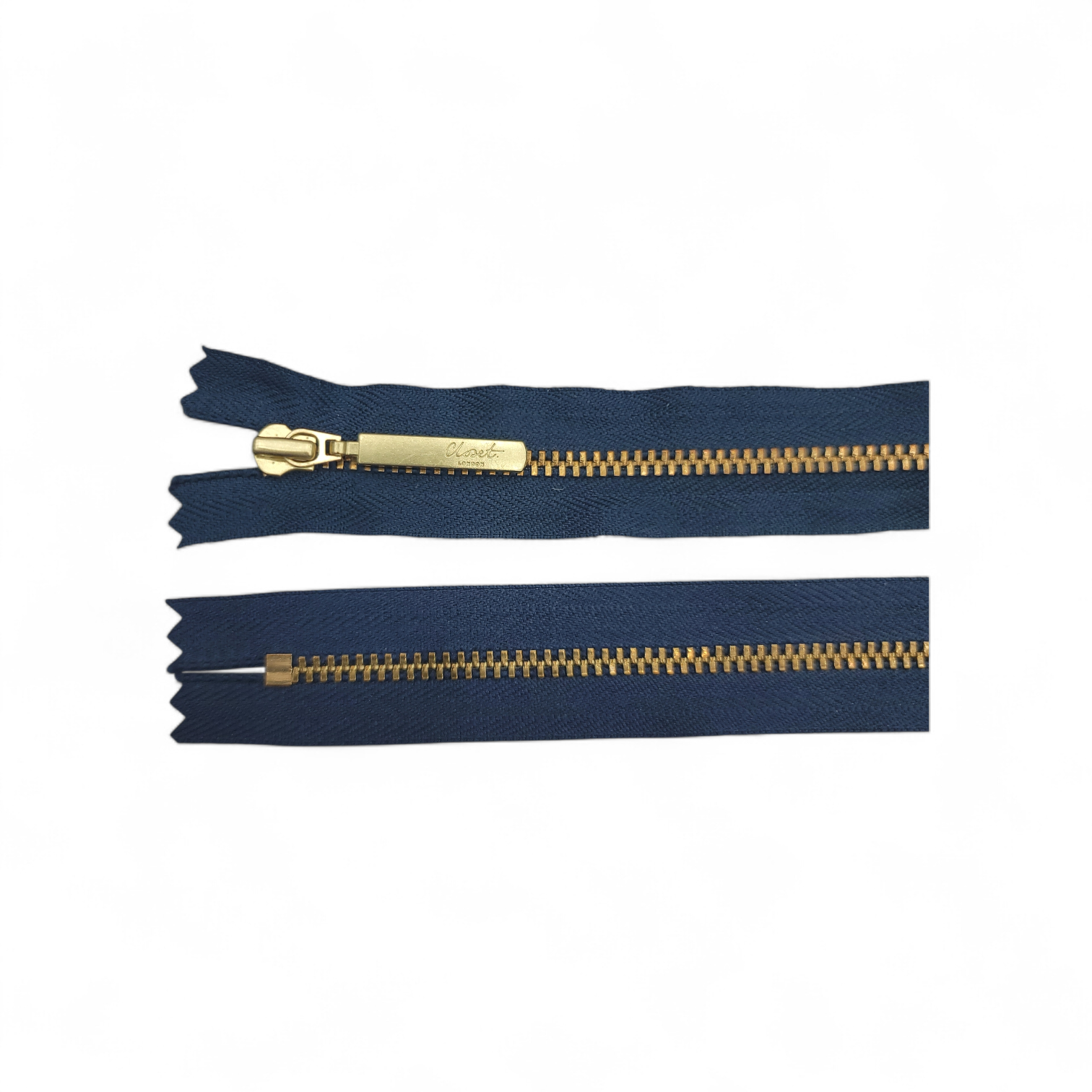 YKK Size 3 closed end gold metal zip on navy fabric.