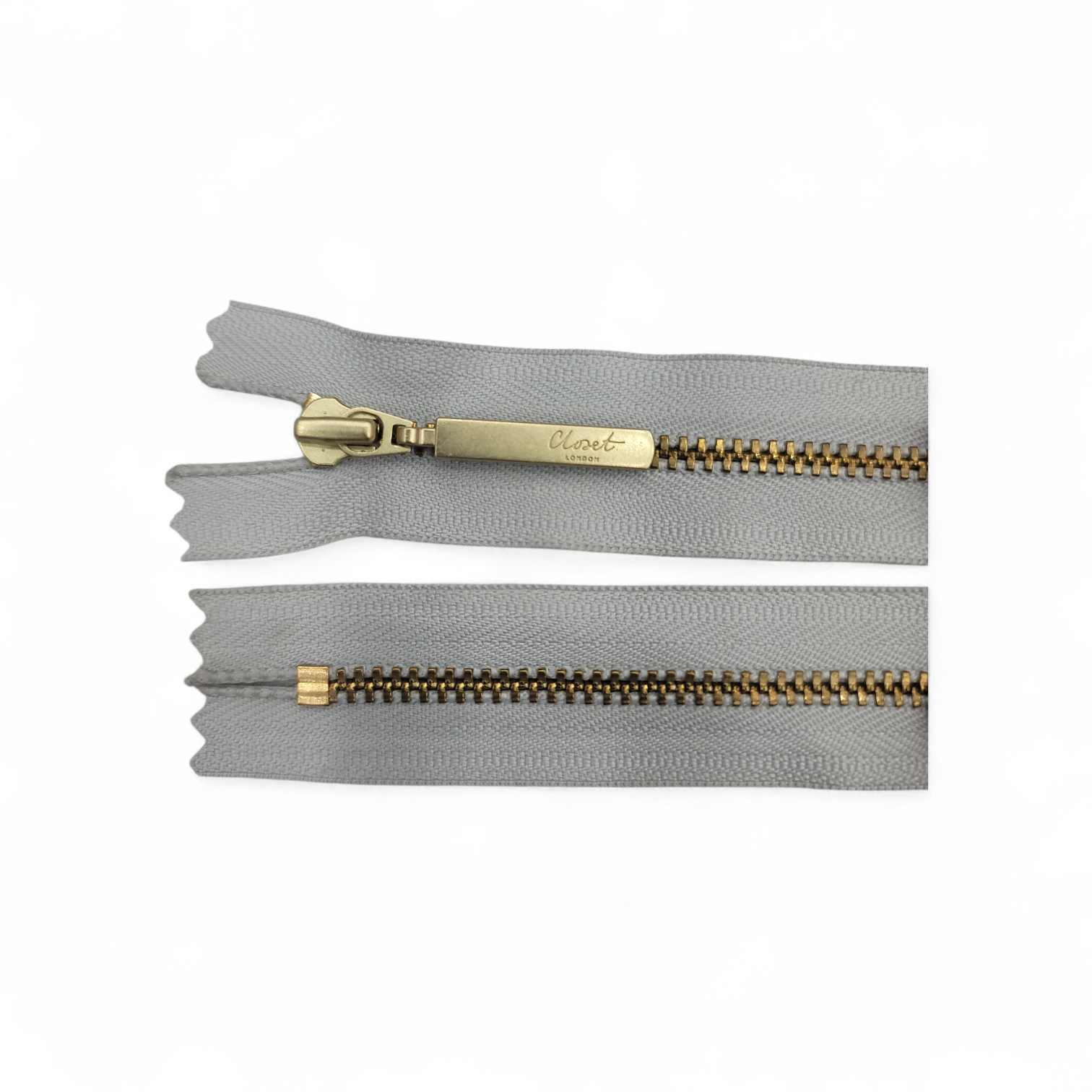YKK Size 3 closed end gold metal zip with grey tape.