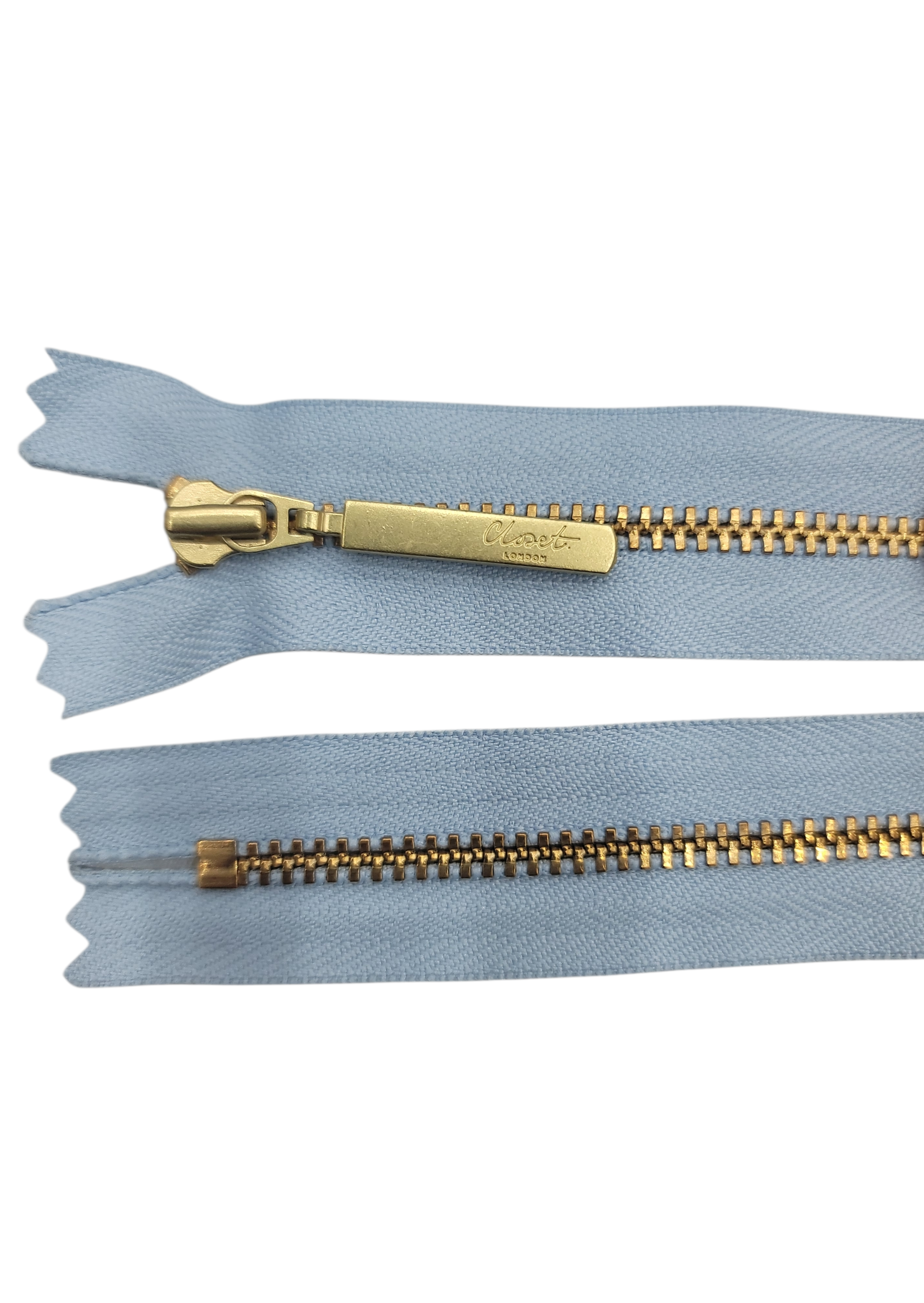 YKK size 3 closed end gold metal zip with light blue tape.
