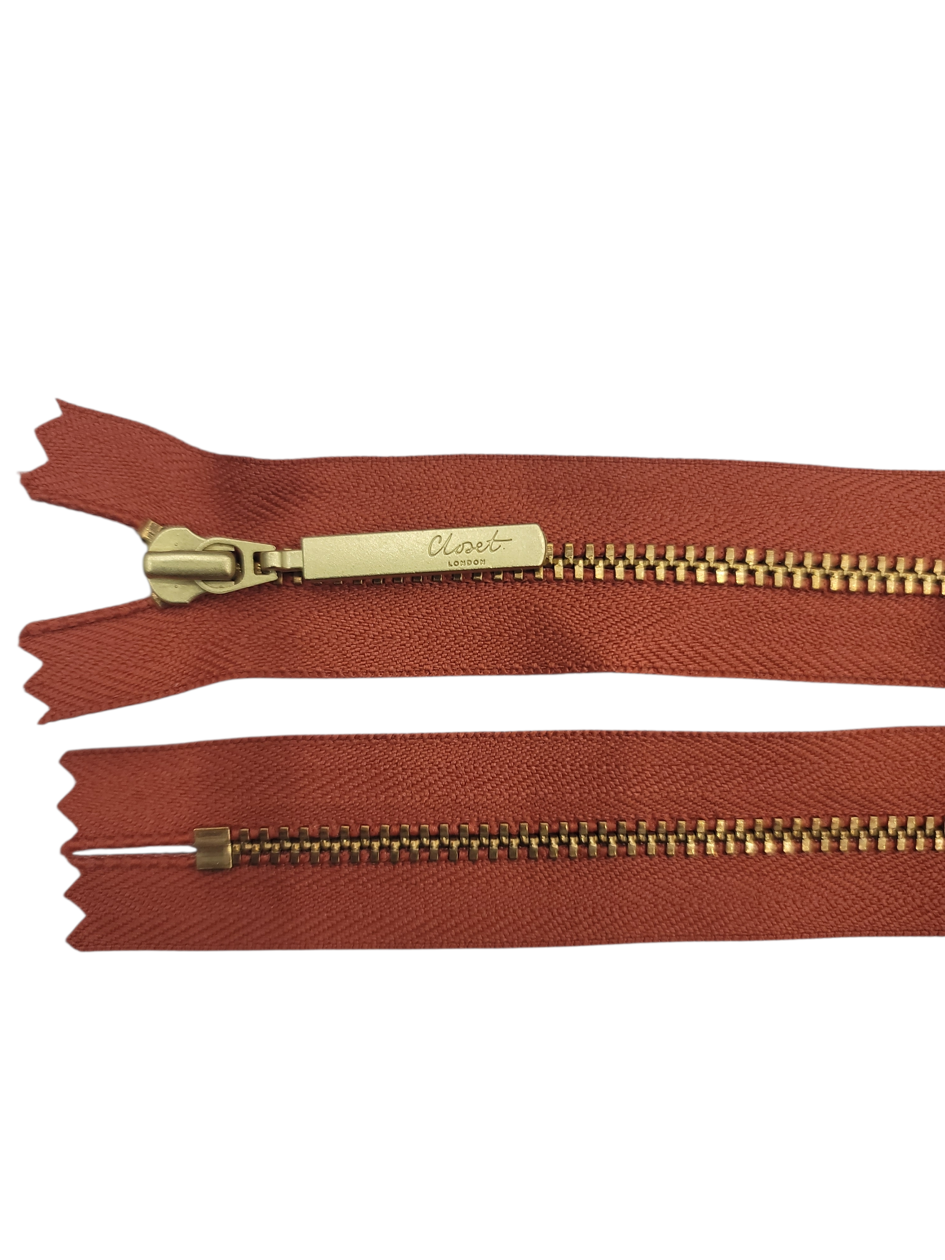 YKK Size 3 closed end gold metal zipper with brown tape.