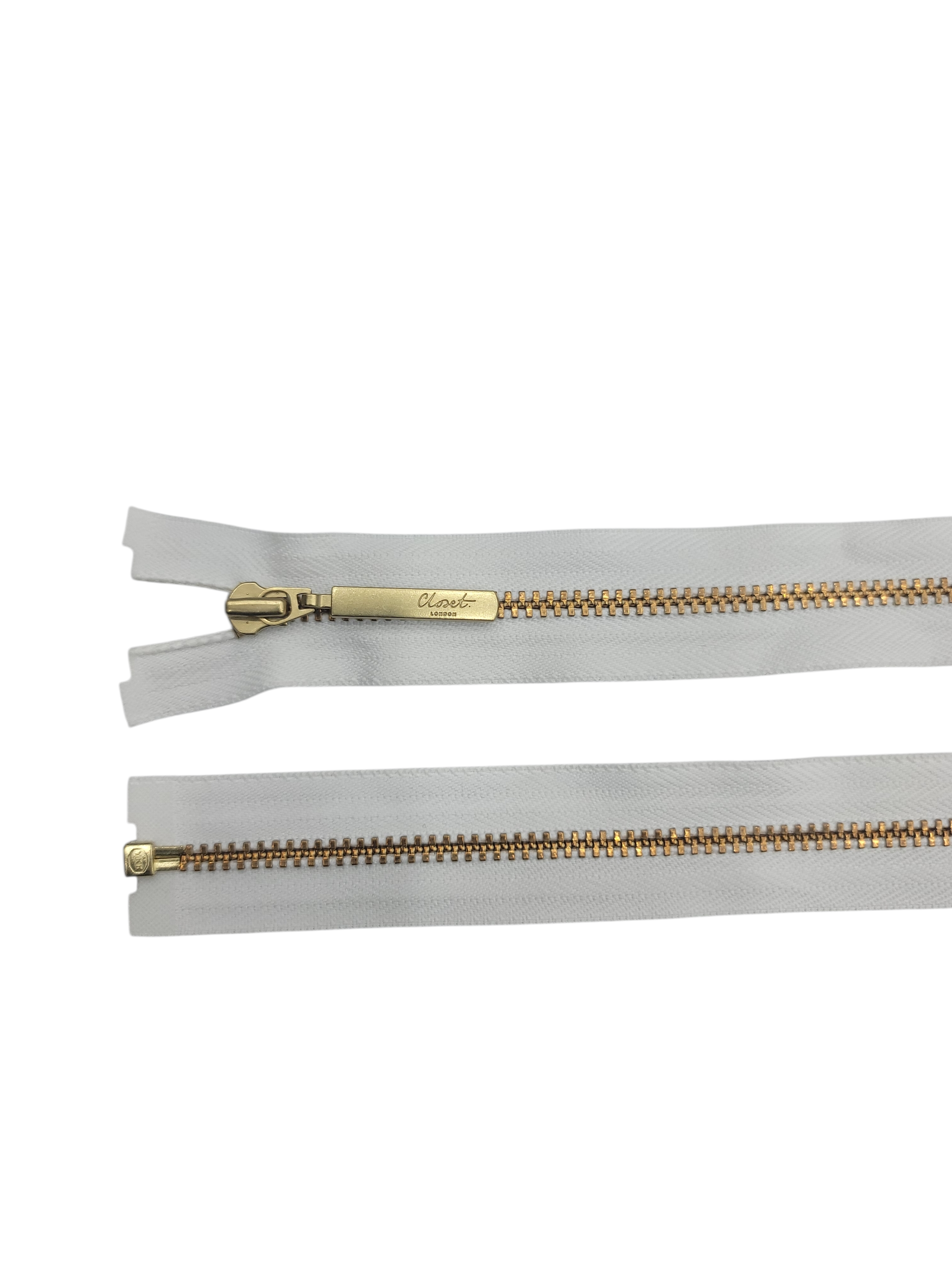 YKK size 3 open end gold metal zipper with white tape.