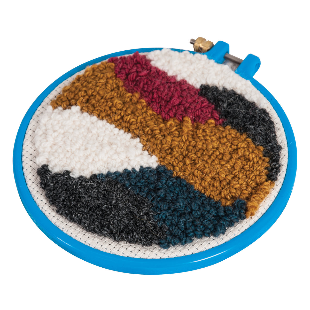 Blue punch needle hoop holding a finished colorful abstract yarn design on white fabric.